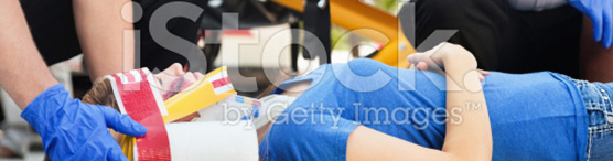 stock-photo-20580460-woman-in-an-ambulance-stretcher-being-treated-by-medicscropped